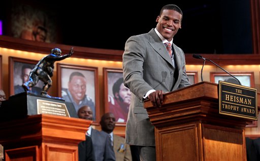 
 In this photo provided by the Heisman Trophy Trust, Auburn quarterback Cam Newton looks at the trophy while he makes his acceptance speech after being named the Heisman Trophy winner, Saturday, Dec. 11, 2010, in New York. (AP Photo/Heisman Trophy Trust, Kelly Kline) ** NO SALES **
 