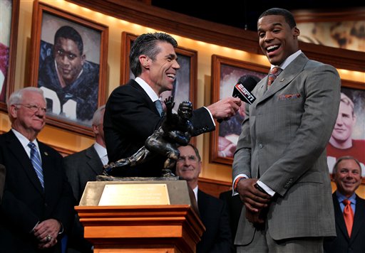
 In this photo provided by the Heisman Trophy Trust, Auburn quarterback Cam Newton, right, speaks with Chris Fowler, center, after being named the Heisman Trophy winner, Saturday, Dec. 11, 2010, in New York. (AP Photo/Heisman Trophy Trust, Kelly Kline) ** NO SALES **
 