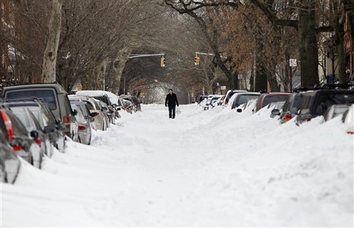 
 A man walks down the center of a snow-filled street in the Brooklyn borough of New York on Tuesday, Dec. 28, 2010. (AP Photo/Seth Wenig)
 