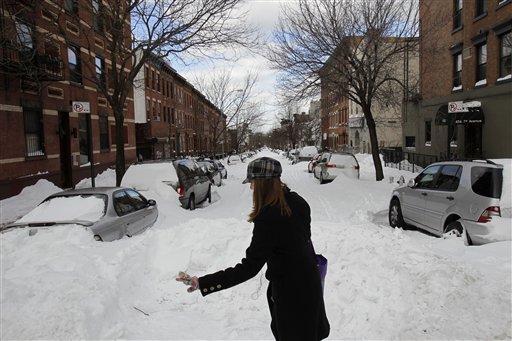 
 A woman makes her way gingerly through an intersection, past an unplowed street, in New York, Tuesday, Dec. 28, 2010. (AP Photo/Seth Wenig)
 