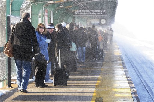 
 Snow blows from a passing train as people wait for a train at the Princeton Junction station Tuesday, Dec. 28, 2010, in West Windsor, N.J. The weekend storm has disrupted train schedules. (AP Photo/Mel Evans)
 