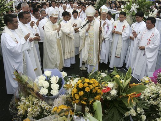 
 Roman Catholic Bishop Broderick Pabillo, fourth from right, and other priests, bless the site where eight Hong Kong tourists were killed in a nearly 12-hour bus hostage standoff on Aug. 23, 2010, involving a dismissed police officer, at Manila's Rizal Park in the Philippines, Tuesday, Aug. 31, 2010. The 'Mass for Peace and Non-violence' was held as the Philippines worked to calm China's outrage over the bloodshed. (AP Photo/Bullit Marquez)
 