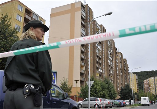
 A Slovakian policewoman secures the building where an unknown man opened fire killing a number of people and wounding more than a dozen people in Bratislava, on Monday, Aug. 30, 2010. The man shot with a scatter-gun and a submachine gun at passers-by and at house windows in a street in Devinska Nova Ves, on Bratislava�s northwestern outskirts. (AP Photo/Bela Szandelszky)
 