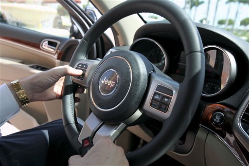 
 In this Aug. 11, 2010 photo, the interior of a 2011 Jeep Grand Cherokee Limited 4x4 is shown at the Planet Dodge Chrysler Jeep dealership in Doral, Fla. Chrysler Group LLC said Wednesday, Sept. 1, 2010, its August sales rose 7 percent over July as many of its models saw gains. (AP Photo/Wilfredo Lee)
 
