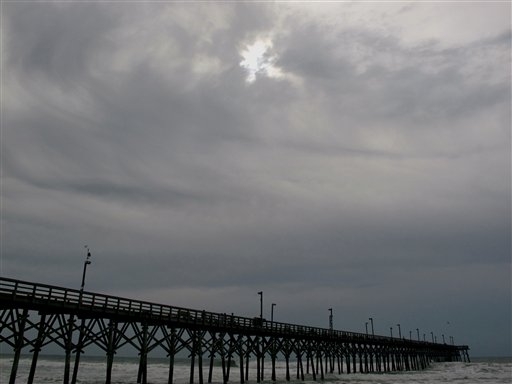 
 Clouds from the advancing rainbands of Hurricane Earl shroud the sun over the pier in Surf City, N.C. on Thursday, Sept. 2, 2010. (AP Photo/Bruce Smith)
 