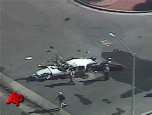 
 In this framegrab made from video provided by KTNV via APTN, wreckage of a single-engine Piper Cherokee on a residential street in Henderson, Nev. The small plane crashed and burst into flames on a street in a southern Nevada residential neighborhood Monday, killing one person and badly injuring three others, authorities said. (AP Photo/KTNV via APTN)
 