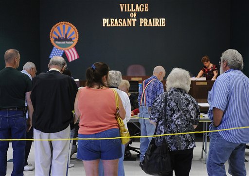 Voters wait in line at the voting poll at Pleasant Prairie, Wis ...