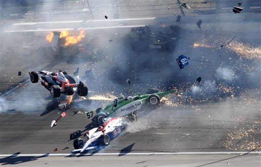 
 Drivers crash during a wreck that involved 15 cars during the IndyCar Series' Las Vegas Indy 300 auto race at Las Vegas Motor Speedway in Las Vegas on Sunday, Oct. 16, 2011. Will Power (12), of Australia, is airborne at left. Dan Wheldon died following the crash. (AP Photo/Las Vegas Review-Journal, Jessica Ebelhar) LAS VEGAS SUN OUT MANDATORY CREDIT
 
