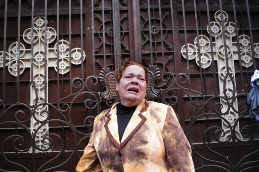
 An Egyptian Christian grieves outside the Coptic Christian Saints Church in the Mediterranean port city of Alexandria, Egypt, Saturday, Jan. 1, 2011. A car exploded in front of the church early Saturday as worshippers emerged from a New Year's Mass, killing at least 21 people according to officials, and sparking clashes between Christians and Muslims, a sign of the sectarian anger that has been arising with greater frequency in Egypt. (AP Photo/Tarek Fawzy)
 
