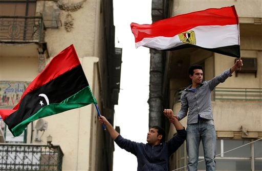 Individuals waving Egyptian and Libyan Flags