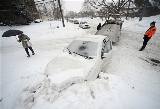 
 A car that hit a snowbank is towed during a winter storm in Hartford, Conn., Tuesday, Feb. 1, 2011. The storm dumped more snow and a dangerous mix of ice, sleet and rain Tuesday on Connecticut as winter-weary residents worried about roof collapses and how to get to work while utilities braced for power outages. (AP Photo/Jessica Hill)
 