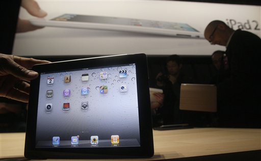 
 FILE - In this file photo taken March 2, 2011, the iPad 2 is shown at an Apple event after the Yerba Buena Center for the Arts Theater in San Francisco. The new iPad model hitting stores Friday, March 11, comes with several improvements but the same price tag as the original version, hobbling efforts by rivals at breaking Apple Inc.�s hold on the emerging market for tablet computers.(AP Photo/Jeff Chiu)
 