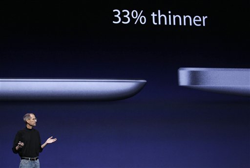
 FILE - In this file photo taken March 2, 2011, Apple Inc. Chairman and CEO Steve Jobs stands under images of the iPad 2, left, and the iPad at an Apple event at the Yerba Buena Center for the Arts Theater in San Francisco. The new iPad model hitting stores Friday, March 11, comes with several improvements but the same price tag as the original version, hobbling efforts by rivals at breaking Apple Inc.�s hold on the emerging market for tablet computers. (AP Photo/Jeff Chiu, file)
 