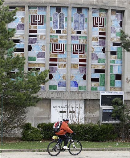 
 A man rides his bicycle past the Taylor Road Synagogue, Tuesday, April 12, 2011, in Cleveland Heights, Ohio. Authorities were working to confirm the identity of man in police custody in Ohio who's believed to be a suspect in the explosion outside a Santa Monica synagogue last week. A man thought to be Ron Hirsch, 60, was taken into custody in Cleveland Heights, Ohio late Monday. (AP Photo/Tony Dejak)
 