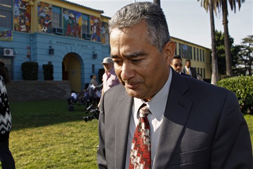 
 Miramonte Elementary school principal Martin Sandoval walks out to address the media outside the school in Los Angeles on Tuesday, Jan. 31, 2012. Veteran Miramonte Elementary school teacher Mark Berndt, 61, was arrested on charges of lewd conduct with 23 children after a film processor gave police photos showing blindfolded children with their mouths taped and cockroaches on their faces. Berndt, 61, not seen, was arrested Jan. 30, 2012 and remained jailed Tuesday on $2.3 million bail. (AP Photo/Damian Dovarganes)
 