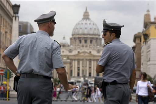 
 FILE - In this Tuesday, Sept. 21, 2010 file photo Italian financial Police officers talk, in front of St. Peter's square at the Vatican. The Vatican is being besieged by near-daily leaks of confidential documents and tabloid-style reports about alleged money laundering at the Vatican bank, and in news reports Saturday Feb. 11, 2012, some conspiracy theorists highlight the upcoming crowning of 22 new cardinals, who will be partly responsible for electing the successor to the Pope himself. (AP Photo/Angelo Carconi, File)
 