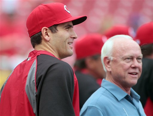 
 Cincinnati Reds' Joey Votto, left, stands Reds general manager Walt Jocketty during batting practice before an exhibition baseball against the Reds Futures minor league team, Tuesday, April. 3, 2012 in Cincinnati. (AP Photo/Tony Tribble)
 