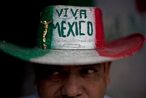 
 Street vendor Victor Manuel Jimenez, 44, poses for a portrait outside his home as he wears a hat that reads in Spanish 'Long live Mexico' in Tijuana, Mexico, Wednesday Oct. 6, 2010. A two-week $5 million festival called Innovative Tijuana starts Thursday Oct. 7, 2010 in the border city across from San Diego and aims to showcase the city's economic prowess and cultural riches in an effort to demonstrate the city is no longer in the grip of warring drug traffickers. (AP Photo/Guillermo Arias)
 
