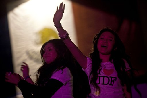 
 In this Oct. 3, 2010 photo, women dance at a concert during the Tijuanarte Art Festival in Tijuana, Mexico. A two-week $5 million festival called Innovative Tijuana starts Thursday Oct. 7, 2010 in the border city across from San Diego and aims to showcase the city's economic prowess and cultural riches in an effort to demonstrate the city is no longer in the grip of warring drug traffickers. (AP Photo/Guillermo Arias)
 