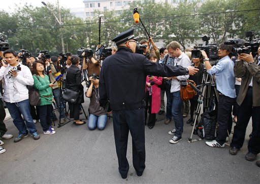 
 A Chinese police officer asks journalists move away from a road entering the apartment house where Liu Xia, wife of Liu Xiaobo stays in Beijing Friday, Oct. 8, 2010. Imprisoned Chinese dissident Liu Xiaobo won the 2010 Nobel Peace Prize on Friday for 'his long and nonviolent struggle for fundamental human rights', a prize likely to enrage the Chinese government, which had warned the Nobel committee not to honor him. (AP Photo/Andy Wong)
 