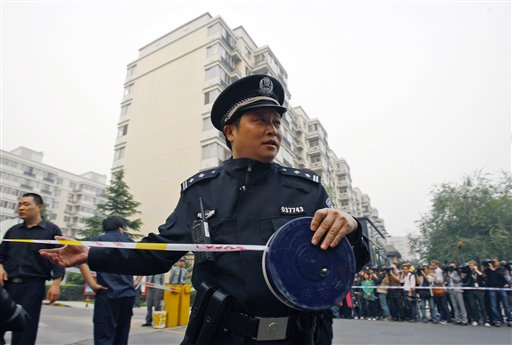 
 A Chinese police officer seals off a road entering the apartment house where Liu Xia, wife of Liu Xiaobo stays in Beijing Friday, Oct. 8, 2010. Imprisoned Chinese dissident Liu Xiaobo won the 2010 Nobel Peace Prize on Friday for 'his long and nonviolent struggle for fundamental human rights', a prize likely to enrage the Chinese government, which had warned the Nobel committee not to honor him. (AP Photo/Andy Wong)
 