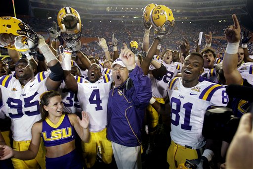 
 LSU head coach Les Miles, center, celebrates with players Lazarius Levingston (95), Jai Eugene (4), Armand Williams (81) and the rest of the team after defeating Florida 33-29 in an NCAA college football game in Gainesville, Fla., Saturday, Oct. 9, 2010.(AP Photo/John Raoux)
 