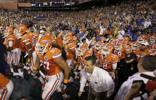 
 Florida players with head coach Urban Meyer, lower right, take the field for an NCAA college football game against LSU in Gainesville, Fla., Saturday, Oct. 9, 2010.(AP Photo/John Raoux)
 