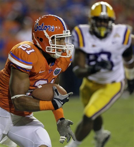 
 Florida running back Emmanuel Moody (21) runs for yardage as he tries to get past LSU tight end Mitch Joseph during the first half of an NCAA college football game in Gainesville, Fla., Saturday, Oct. 9, 2010.(AP Photo/John Raoux)
 