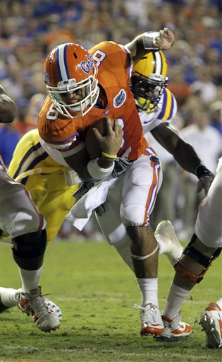 
 Florida quarterback Trey Burton (8) runs past LSU linebacker Kelvin Sheppard for a 1-yard touchdown during the first half of an NCAA college football game in Gainesville, Fla., Saturday, Oct. 9, 2010.(AP Photo/John Raoux)
 