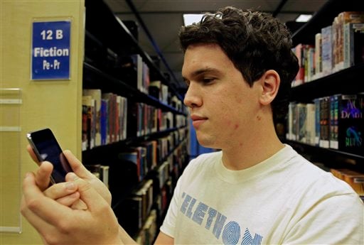 
 Hillard Goodspeed uses an ipod application called 'shake it', to find reading suggestions at the Orlando Public Library in Orlando, Fla., Wednesday, Sept. 1, 2010.(AP Photo/John Raoux)
 