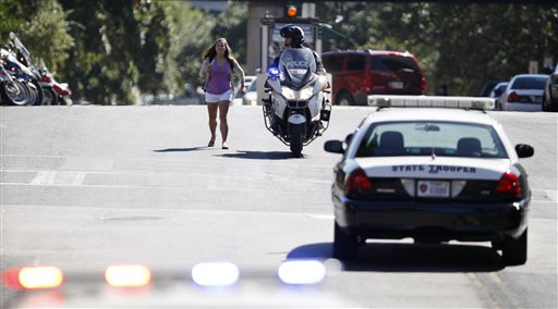 
 A police officer escorts a student off the University of Texas campus after a gunman opened fire then killed himself inside a library, Tuesday, Sept. 28, 2010 in Austin. (AP Photo/Eric Gay)
 
