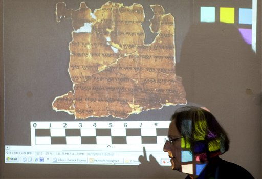 
 Pnina Shor, Head of the Dead Sea Scrolls Project at the IAA, Israel Antiquities Authority, walks past a projector showing a fragment of the Dead Sea Scrolls, during a joint IAA and Google press conference in Jerusalem, Tuesday, Oct. 19, 2010. Israel's Antiquities Authority and Google announced Tuesday they are joining forces to bring the Dead Sea Scrolls online, allowing both scholars and the general public widespread access to the ancient manuscripts for the first time. (AP Photo/Sebastian Scheiner)
 