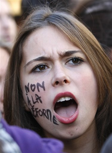 
 A student shouts slogans during a demonstration in Paris, Thursday Oct.21, 2010. Protesters blockaded Marseille's airport, Lady Gaga canceled concerts in Paris and rioting youths attacked police in Lyon on ahead of a tense Senate vote on raising the retirement age to 62. A quarter of the nation's gas stations were out of fuel despite President Nicolas Sarkozy's orders to force open depots barricaded by striking workers. On her cheek reads: No to the reform. (AP Photo/Francois Mori)
 