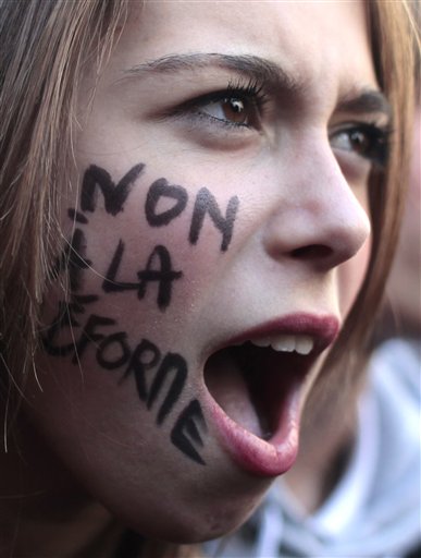 
 A student shouts slogans during a demonstration in Paris, Thursday Oct. 21, 2010. Protesters blockaded Marseille's airport, Lady Gaga canceled concerts in Paris and rioting youths attacked police in Lyon on ahead of a tense Senate vote on raising the retirement age to 62. A quarter of the nation's gas stations were out of fuel despite President Nicolas Sarkozy's orders to force open depots barricaded by striking workers. On her cheek reads: No to the reform. (AP Photo/Thibault Camus)
 