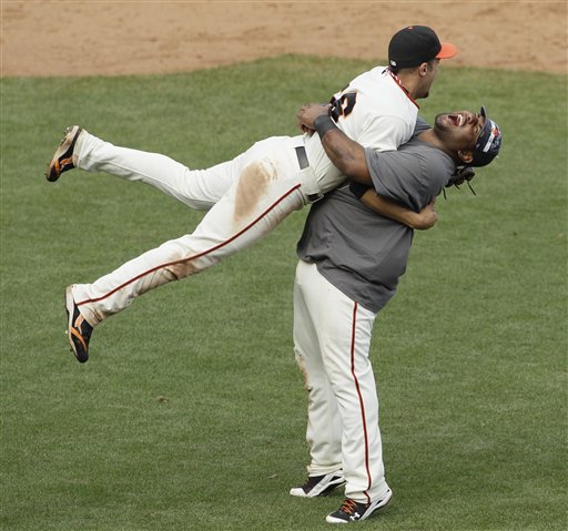 
 San Francisco Giants third baseman Pablo Sandoval, right, picks up center fielder Andres Torres, left, at the end of their baseball game against the San Diego Padres in San Francisco, Sunday, Oct. 3, 2010. San Francisco won the game 3-0 to win the National League West Division title. (AP Photo/Eric Risberg)
 