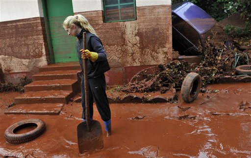 
 Tunde Erdelyi is seen in her yard flooded by toxic mud in the town of Devecser, Hungary, Tuesday, Oct. 5, 2010. Monday's flooding was caused by the rupture of a red sludge reservoir at an alumina plant in western Hungary and has affected seven towns near the Ajkai Timfoldgyar plant in the town of Ajka, 100 miles (160 kilometers) southwest of Budapest. (AP Photo/Bela Szandelszky)
 