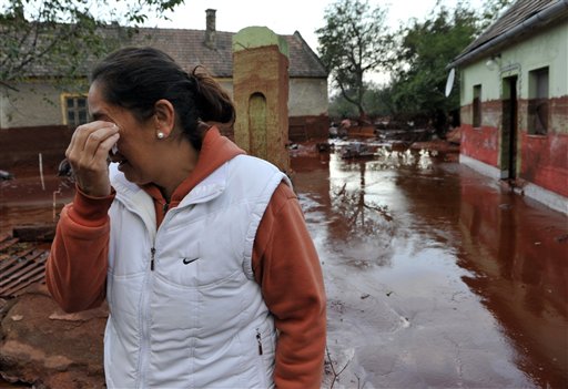 
 Janos Kis tries to return to his home flooded by toxic mud in the town of Devecser, Hungary, Tuesday, Oct. 5, 2010. Monday's flooding was caused by the rupture of a red sludge reservoir at an alumina plant in western Hungary and has affected seven towns near the Ajkai Timfoldgyar plant in the town of Ajka, 100 miles (160 kilometers) southwest of Budapest. (AP Photo/Bela Szandelszky)
 
