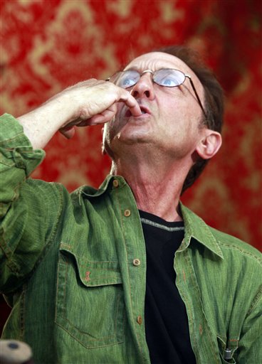 
 Missing hiker Ed Rosenthal shows how he was able to drink rain water collected onto his hand while being lost inside Joshua Tree National Park, during a news conference Tuesday Oct. 5, 2010 in Los Angeles.. (AP Photo/Damian Dovarganes)
 