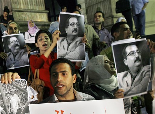 
 FILE - In this Sunday, Sept. 28, 2008 file photo, Egyptian journalists protest with posters showing Ibrahim Eissa, chief editor of the independent Al-Dostor newspaper, after an appeals court upheld a guilty verdict against him for stories questioning the Egyptian president's health, in Cairo, Egypt. One of Egypt's leading independent newspapers said Tuesday, Oct. 5, 2010 that its mogul publisher Elseyed el-Badawi has fired the daily's chief editor Ibrahim Eissa, known as an outspoken critic of the regime of President Hosni Mubarak. (AP Photo/Amr Nabil, File)
 