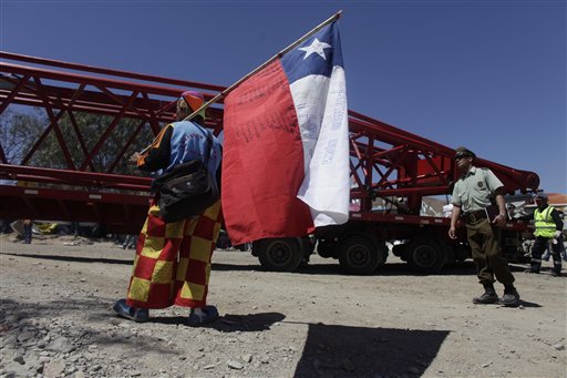 
 Rolando 'Rolly' Gonzalez, a miner who doubles as a clown to entertain the children of the trapped miners, watches as a giant crane arrives at the San Jose Mine near Copiapo, Chile, Wednesday Oct. 6, 2010. Thirty-three miners have been trapped deep underground in the copper and gold mine since it collapsed on Aug. 5.(AP Photo/Dario Lopez-Mills)
 