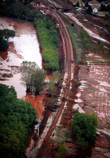 
 An aerial view of workers repairing a section of a railway line washed away by red mud in Devecser, 164 kms southwest of Budapest, Hungary, Wednesday, Oct. 6, 2010, after a dike of a reservoir containing red mud of a metals factory in nearby Ajka broke on Monday, and over one million cubic meters of the poisonous chemical sludge inundated three villages, killing an unknown number of persons and injuring over hundred. (AP Photo/MTI, Sandor H. Szabo)
 