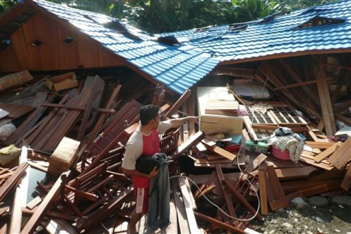 
 In this Monday, Oct. 4, 2010 photo, a resident inspects a house destroyed by flash flood in Wasior, Papua province, Indonesia. Days of torrential rain triggered landslides and flash floods in eastern Indonesia, killing dozens of people and destroying hundreds of homes, officials and witnesses said Tuesday. (AP Photo)
 