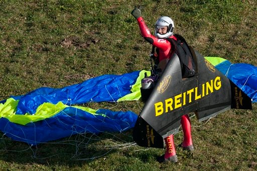 
 Swiss pilot Yves Rossy, the first man in the world to fly under a jet-fitted wing, celebrates after performing a looping in Denezy, western Switzerland, Friday, Nov 5, 2010. Rossy has completed two aerial loops using his custom-made jet-propelled wingsuit. He jumped from a hot-air balloon above Lake Geneva and performed the daredevil stunt before landing safely with a parachute. (AP Photo/Keystone, Laurent Gillieron, pool photo)
 