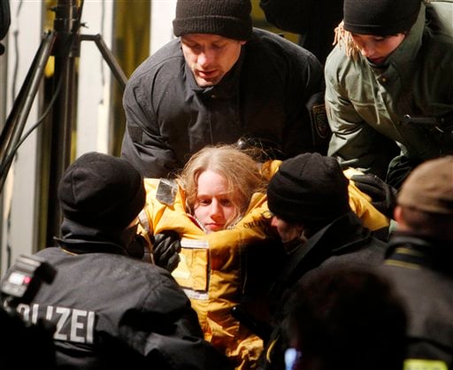 
 A member of environmental organization Greenpeace is carried out of a truck in which she was fixed in a concrete block for more than eleven hours in Dannenberg, northern Germany, early Tuesday, Nov. 9, 2010. The truck with a special box construction inside and under the truck blocked the first cross road where a transport of nuclear way is supposed to pass for more than eleven hours. The castor train with nuclear waste is underway from French La Hague to the nuclear interim storage plant in Gorleben. (AP Photo/Michael Probst)
 