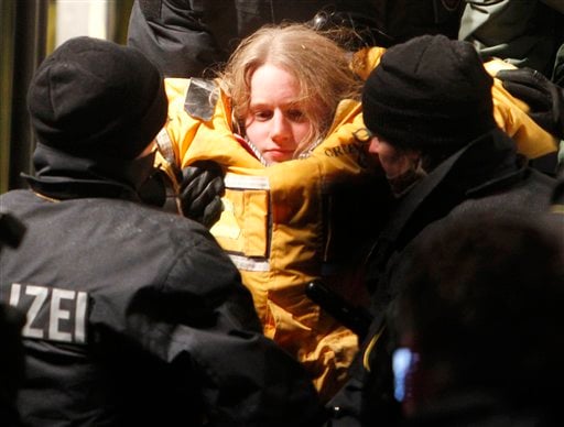
 A member of environmental organization Greenpeace is carried out of a truck by police officers in which she fixed herself in a concrete block for more than eleven hours in Dannenberg, northern Germany, early Tuesday, Nov. 9, 2010. The truck with a special boxes set inside and under that blocked the first crossroad where the transport of nuclear way is supposed to pass for more than eleven hours. The shipment reached a railway depot in Dannenberg on Monday, where workers spent the day transferring containers of nuclear waste from the rails to trucks that are to carry it on the last leg of its journey to the site in Gorleben, 20 kilometers (12 miles) away. (AP Photo/Michael Probst)
 