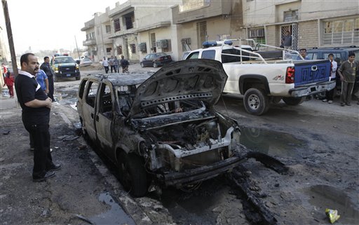 
 Security forces and people gather at the scene of a bomb attack in Baghdad, Iraq, Wednesday, Nov. 10, 2010. A string of bombings targeted Christian houses in Baghdad early Wednesday, killing and wounding several people, police said. (AP Photo/Khalid Mohammed)
 