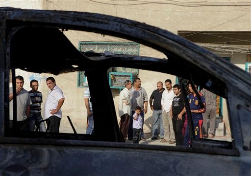 
 People inspect the scene of a bomb attack in Baghdad, Iraq, Wednesday, Nov. 10, 2010. A string of bombings targeted Christian houses in Baghdad early Wednesday, killing and wounding several people, police said. (AP Photo/Khalid Mohammed)
 
