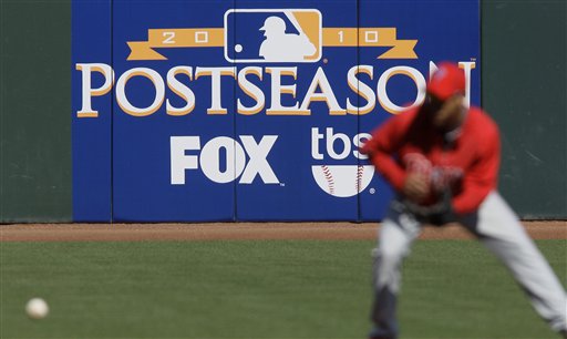
 FILE - In this Oct. 18, 2010 file photo, a Philadelphia Phillies player practices in front of an advertisement for postseason baseball on Fox in San Francisco. Fox and Cablevision reached an agreement Saturday that will restore programming to more than 3 million New York-area subscribers who have been without some of their favorite shows and baseball playoff games for two weeks. (AP Photo/Jeff Chiu, File)
 