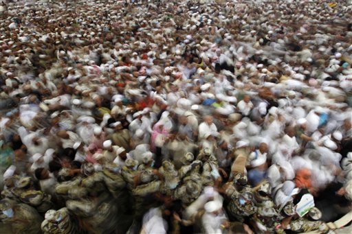 
 Muslim pilgrims cast stones at a pillar, symbolizing the stoning of Satan, in a ritual called 'Jamarat,' the last rite of the annual hajj, in Mina near the Saudi holy city of Mecca, Saudi Arabia in Mecca, Saudi Arabia, Thursday, Nov. 18, 2010. The annual Islamic pilgrimage draws 2.5 million visitors each year, making it the largest yearly gathering of people in the world. (AP Photo/Hassan Ammar)
 