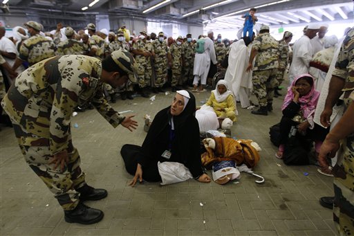 
 A Saudi policeman help a Muslim woman pilgrim after casting stones at a pillar, symbolizing the stoning of Satan, in a ritual called 'Jamarat,' the last rite of the annual hajj, in Mina near the Saudi holy city of Mecca, Saudi Arabia in Mecca, Saudi Arabia, Thursday, Nov. 18, 2010. The annual Islamic pilgrimage draws 2.5 million visitors each year, making it the largest yearly gathering of people in the world. (AP Photo/Hassan Ammar)
 